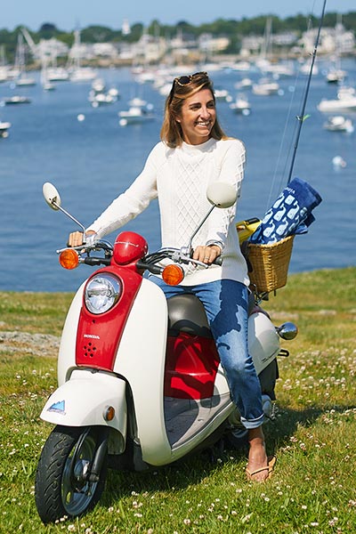 jenny tatelman on a moped down by the water