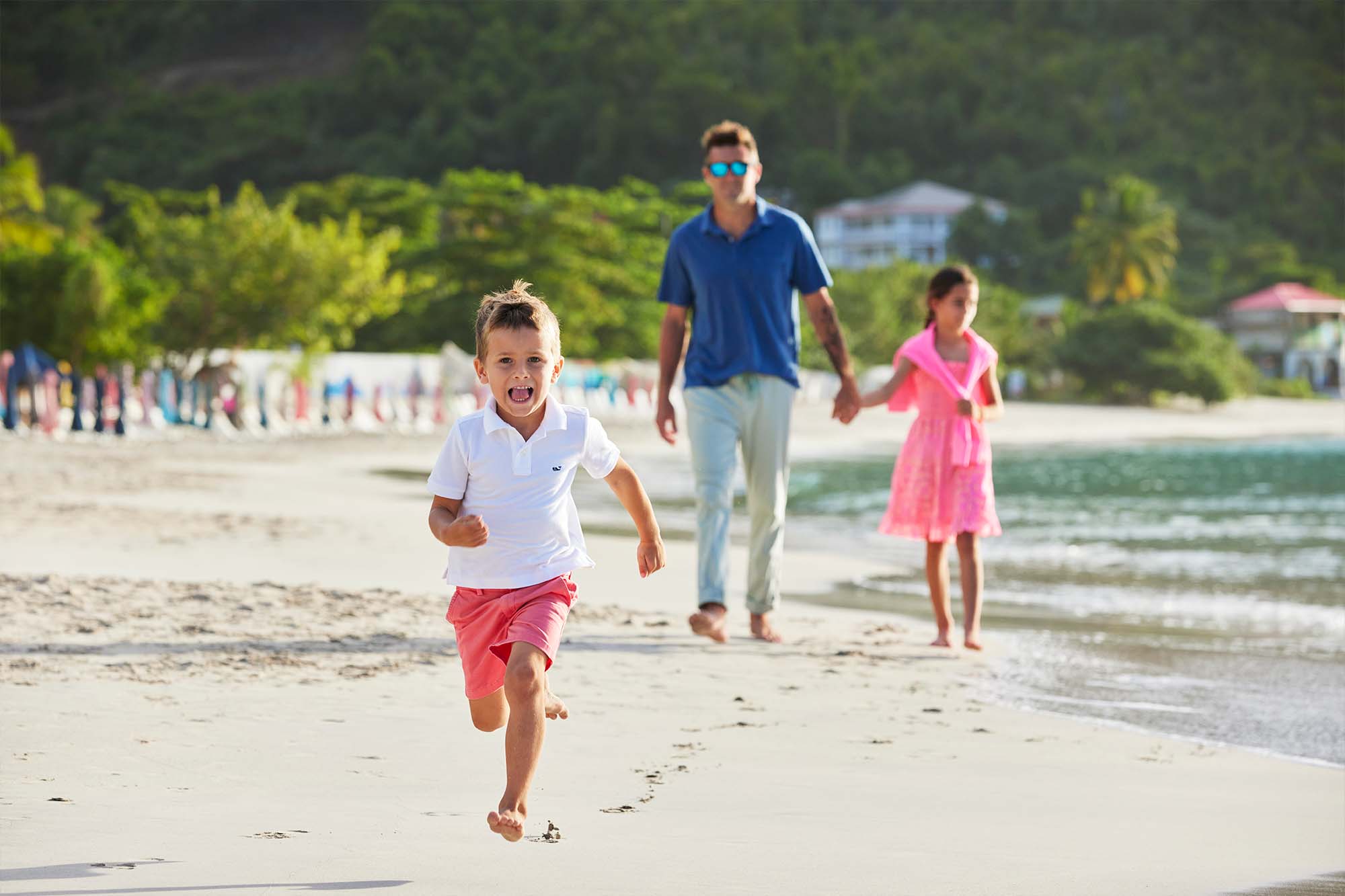 Tom Pinhold and his children on beach shore
