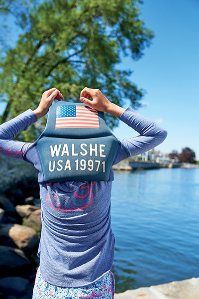 samara walshe puts on her life vest and gets ready for a day of sailing