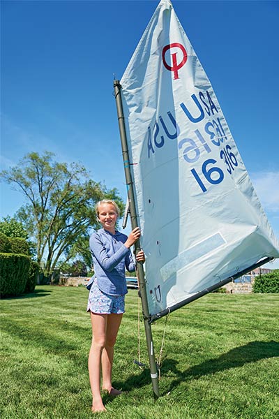 samara walshe poses with her sail