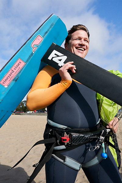 geoff headington carrying his kiteboard into the water